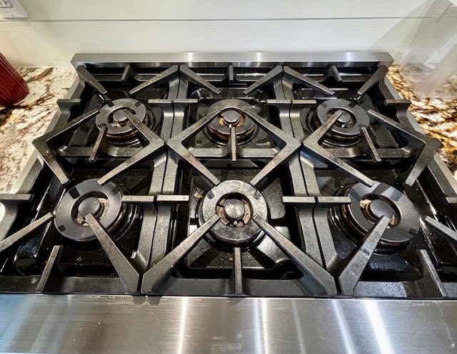 Gleaming kitchen with freshly cleaned stovetop and granite countertops