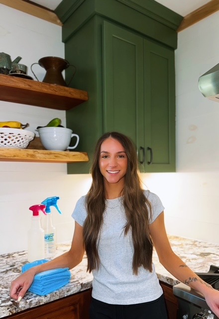 Sarah, owner of Wright's Clean & Shine, in a bright kitchen